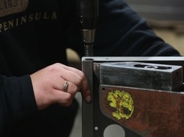 Danielle Guy added metal washers on this panel as a part of her workday at Wyoming Machine, which specializes in precision sheet-metal fabrication.