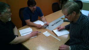 Kent Franklin, Bob Loder and John Hanenburg ponder a cocktail napkin design. While Wyoming Machine can create a part from just about anything submitted to them, CAD designs are considerably faster and more accurate than napkin designs! 