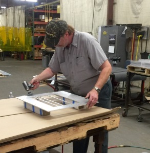 Robert working in the metal finishing department.